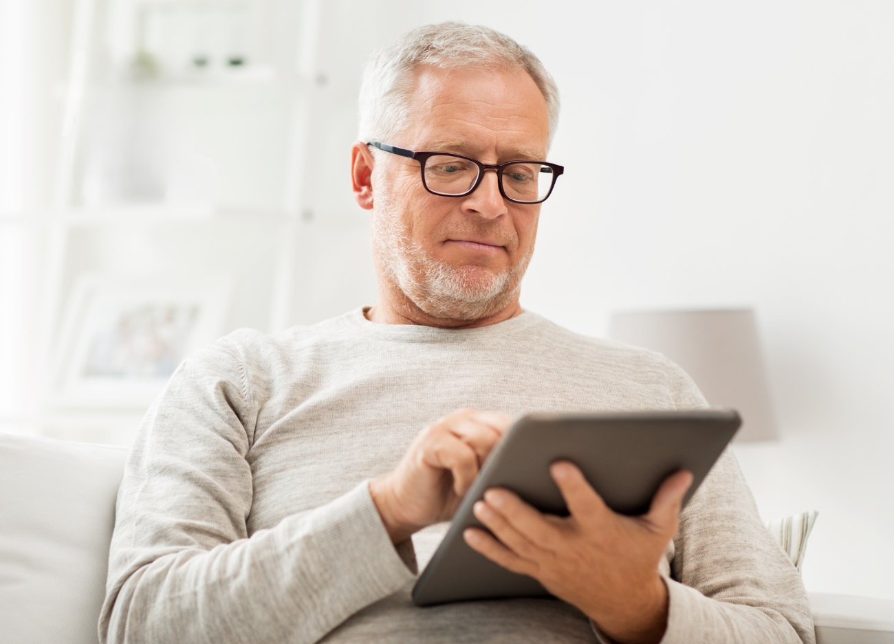 man in 50s reviews report on tablet to assess job passion and consider working with Careerz Group