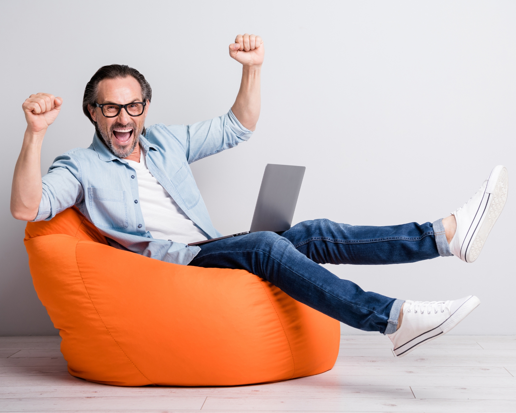 Man is happy after getting results from the Job Passion Assessment. arms raised with glee