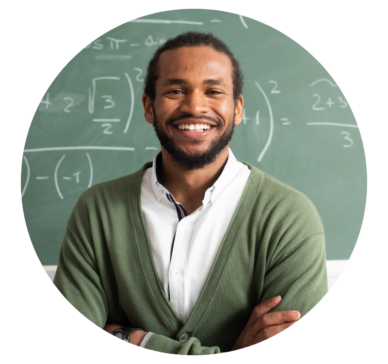 school teacher and class advisor smiles in front of chalk board